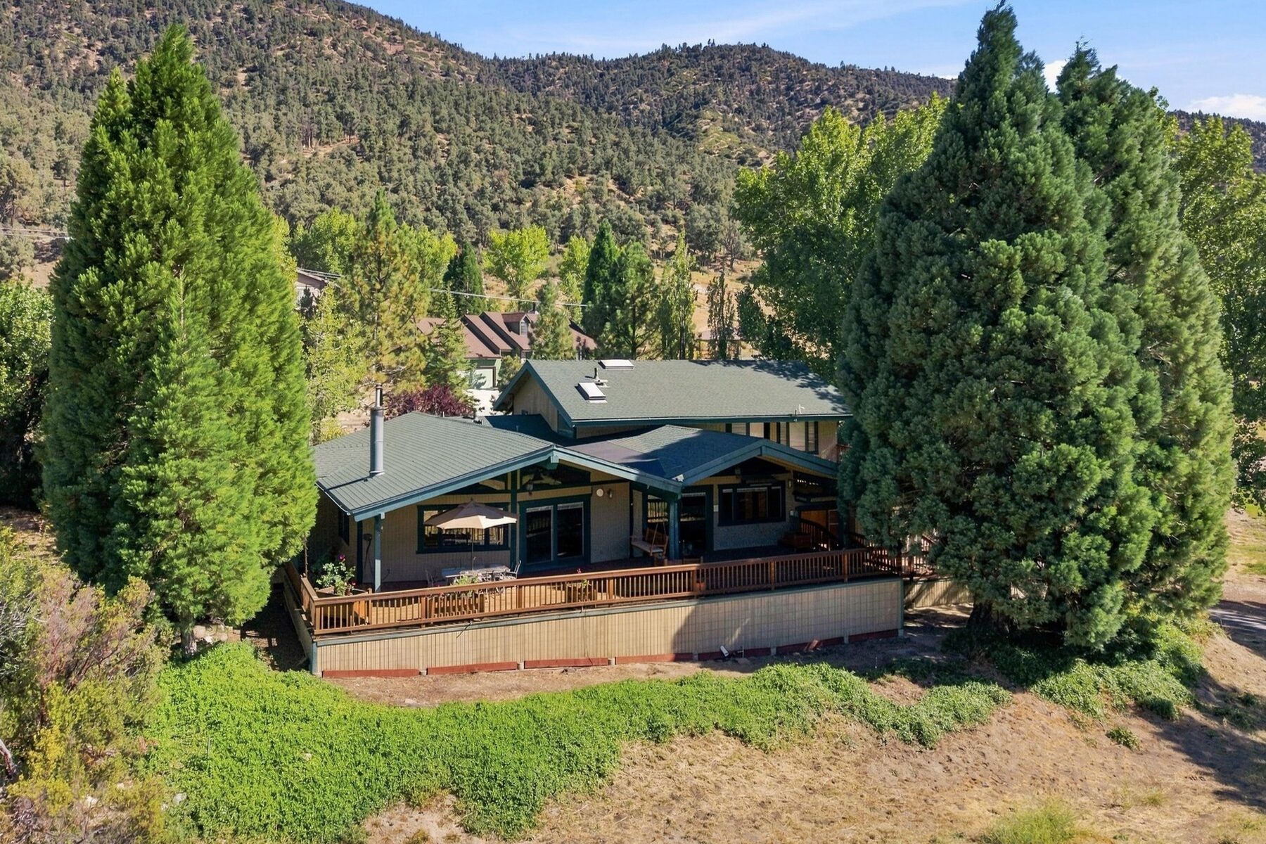 16316 Aleutian Drive — aerial view of the home, decks, and surrounding mountain landscape