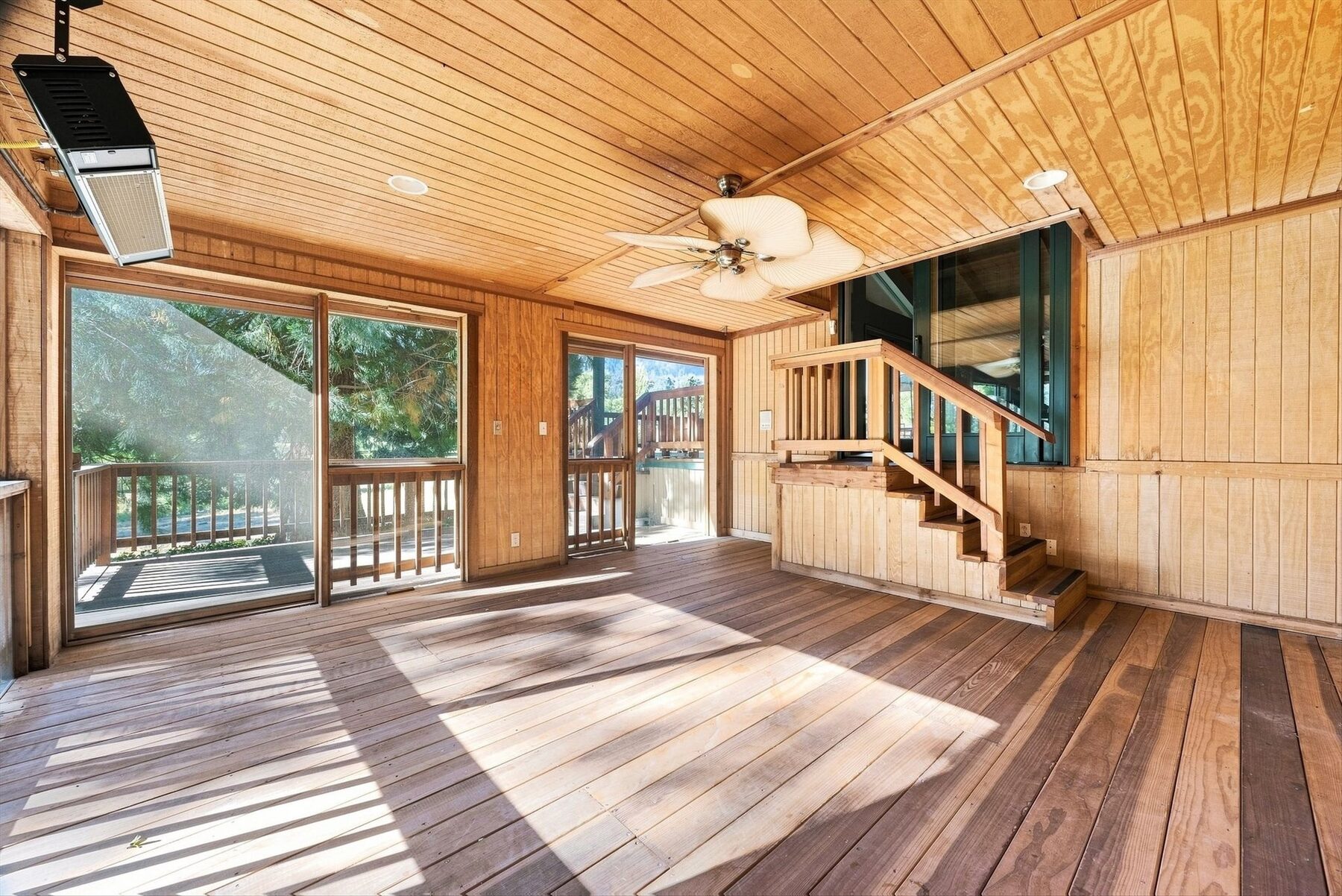 16316 Aleutian Drive — bright enclosed room with wood ceiling, windows, and deck access