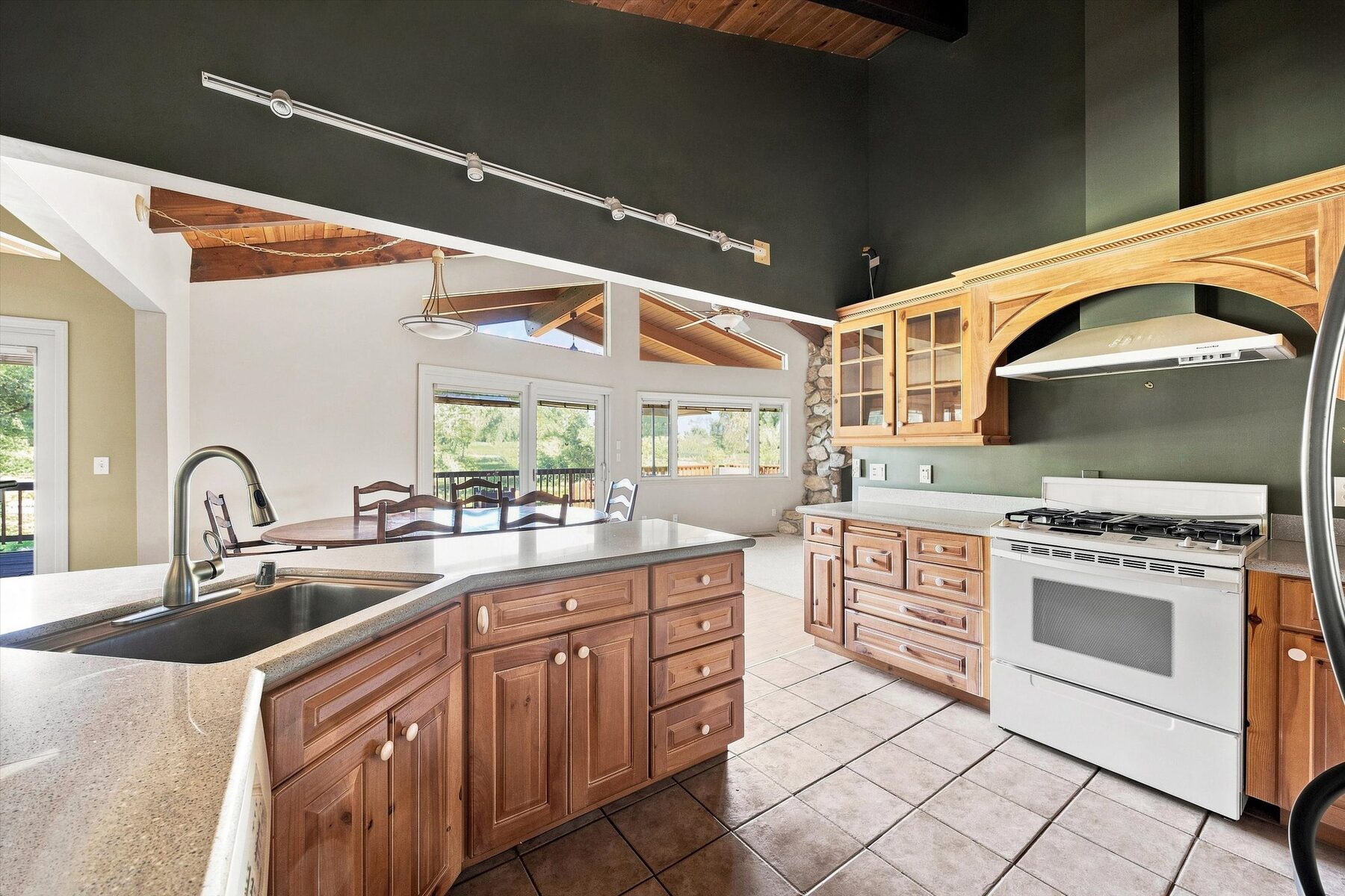 16316 Aleutian Drive — kitchen with wood cabinetry, island, and stainless appliances
