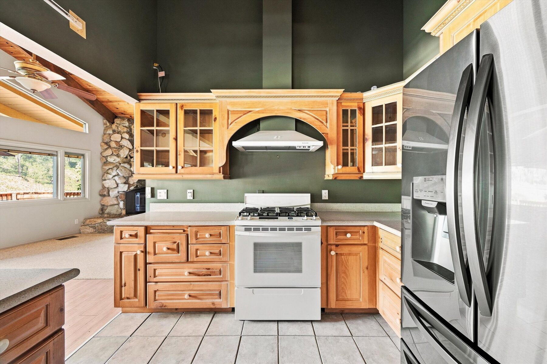 16316 Aleutian Drive — open kitchen and dining area with wood-beamed ceiling