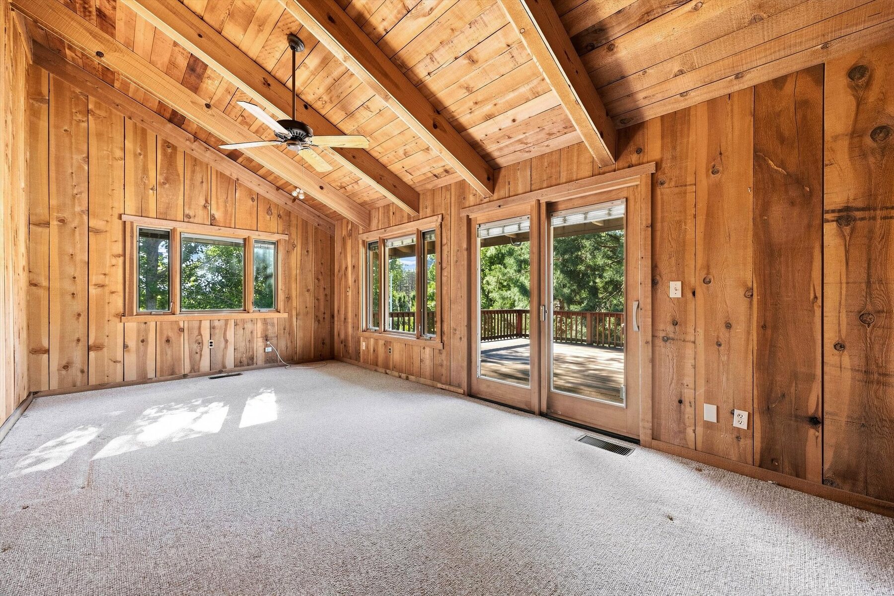 16316 Aleutian Drive — bedroom with vaulted wood ceiling, windows, and deck access