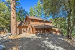 2332 Alpen Court — Front exterior and driveway beneath tall pine trees