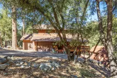 2332 Alpen Court — Mountain home and decks framed by mature trees