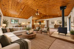 2332 Alpen Court — Living room with vaulted wood ceiling and wood-burning stove