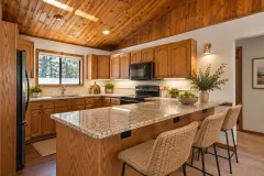 2332 Alpen Court — Kitchen with wood cabinets, granite counters and breakfast-bar seating