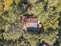 2332 Alpen Court — Aerial view of the home, roof-mounted solar panels and surrounding forest