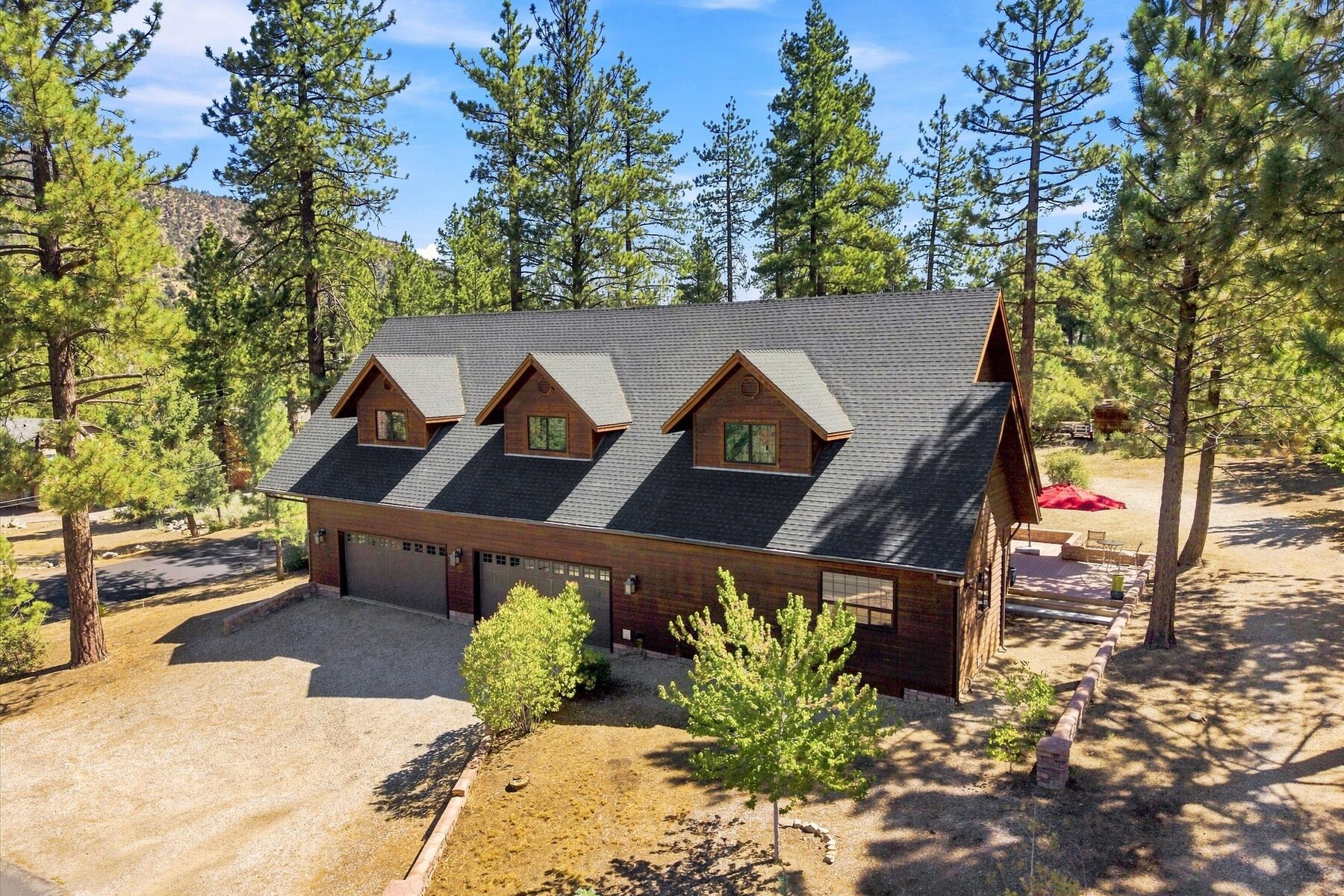 16330 Askin Drive — aerial exterior view of the mountain home surrounded by pine trees