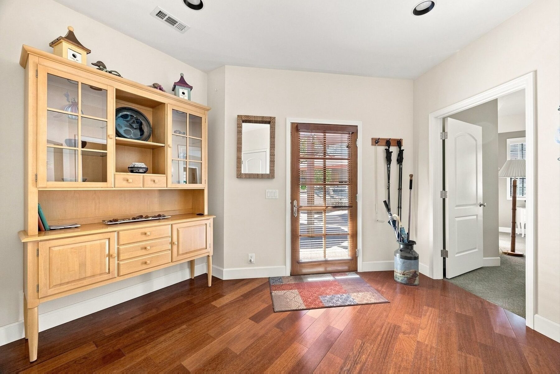 16330 Askin Drive — entry foyer with built-in cabinetry, front door, and hardwood floors