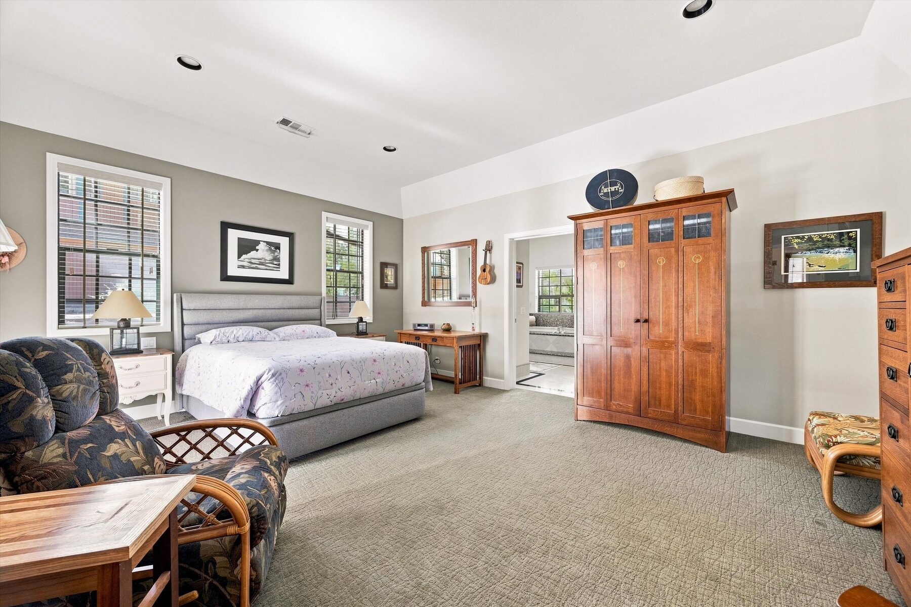 16330 Askin Drive — bedroom with upholstered bed, wood armoire, and natural light