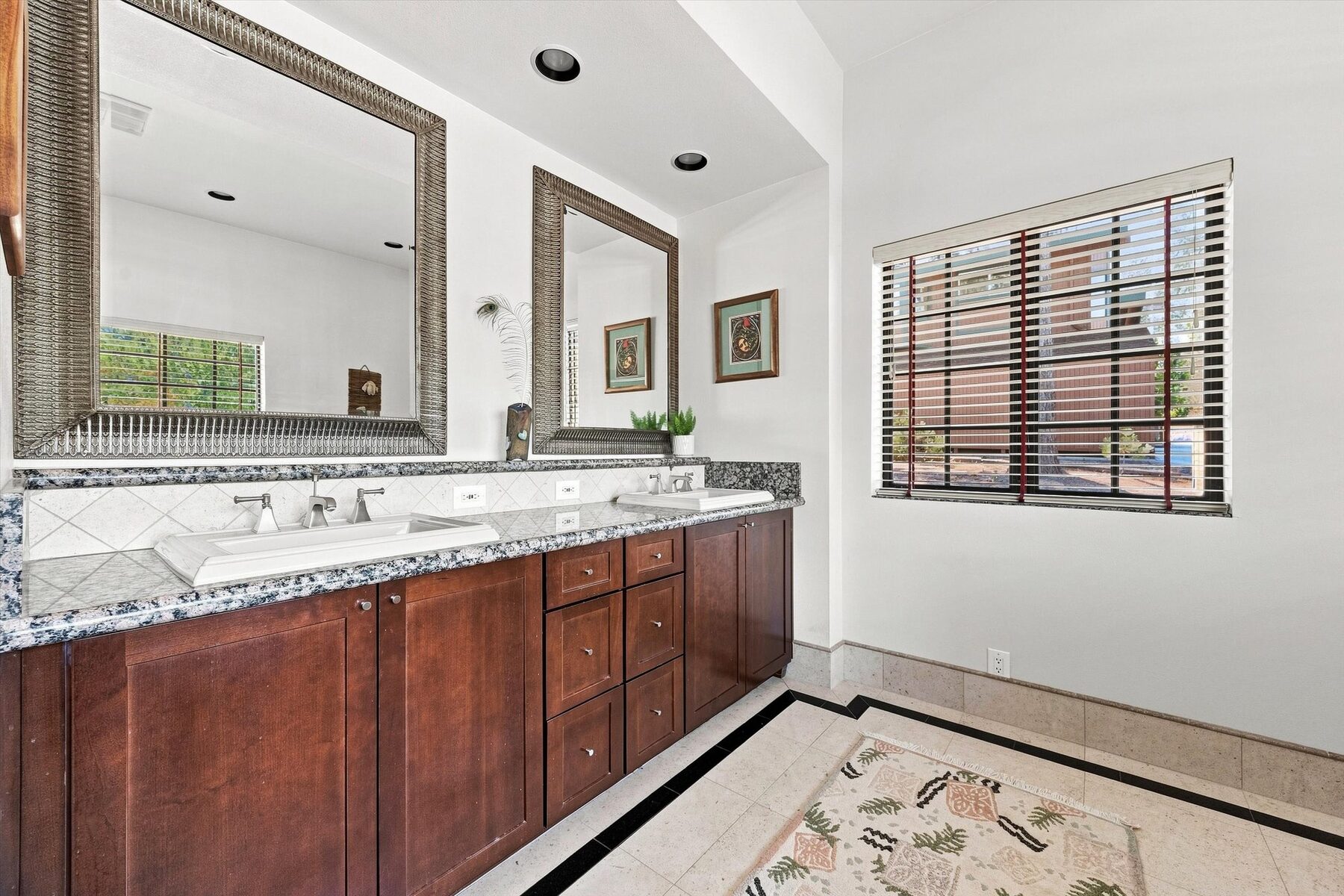16330 Askin Drive — bathroom with double vanity, granite countertop, and wood cabinetry