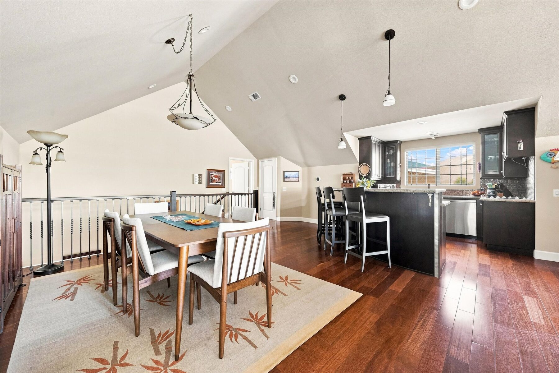16330 Askin Drive — dining area and kitchen with vaulted ceiling and hardwood floors