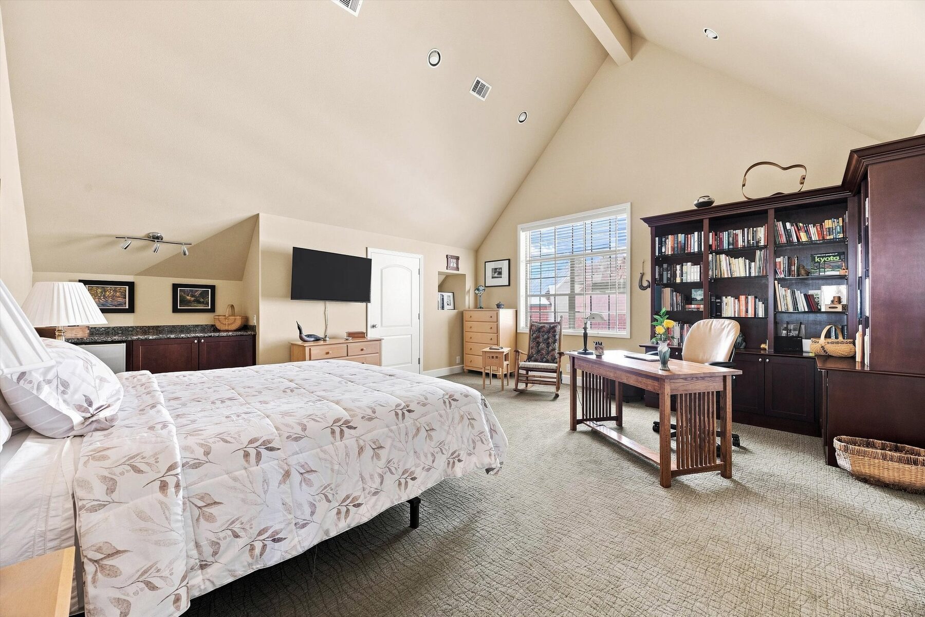 16330 Askin Drive — bedroom with vaulted ceiling, desk, and built-in bookshelves
