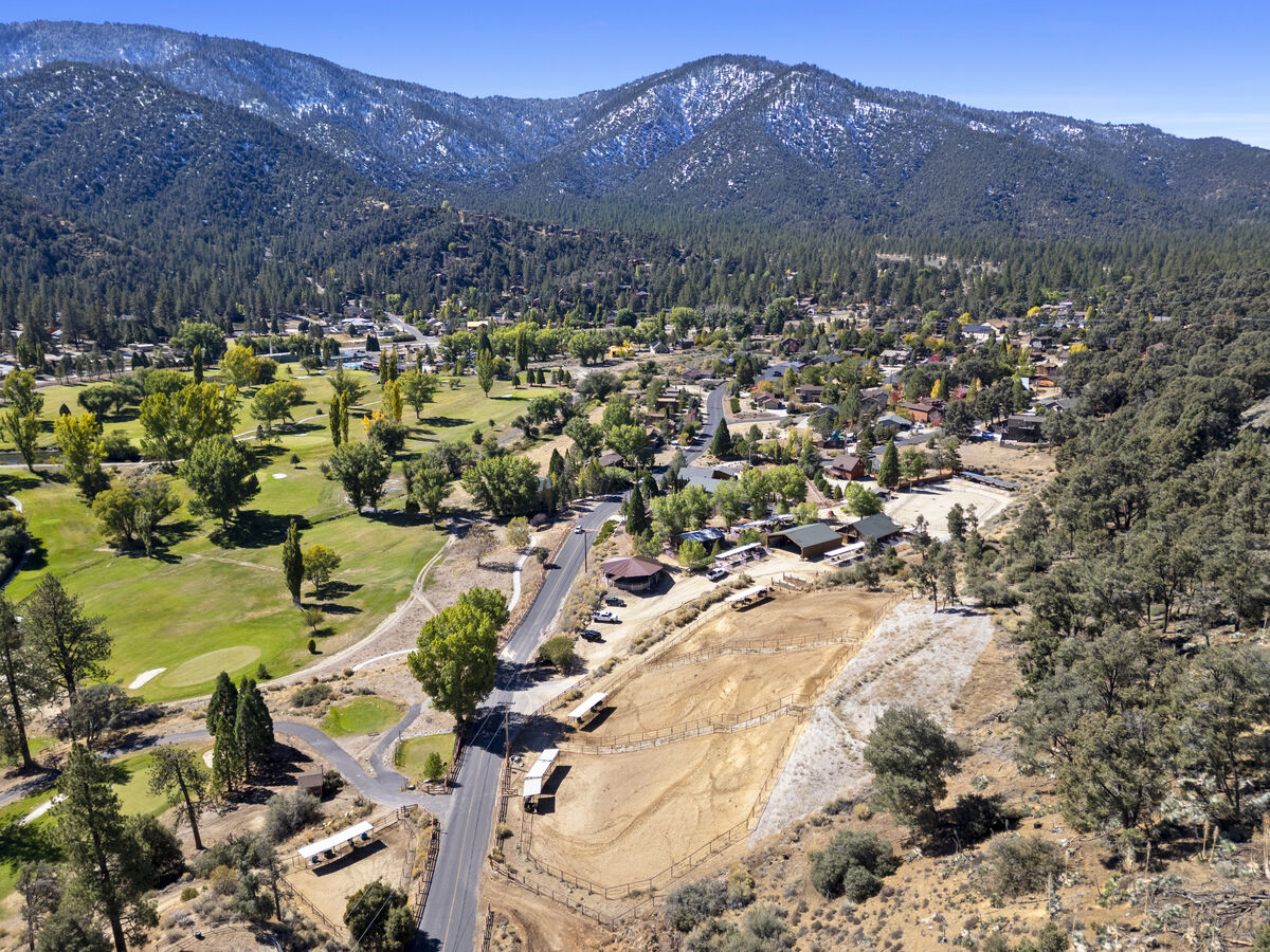 Wide aerial view of PMC Equestrian Center alongside the golf course and mountains