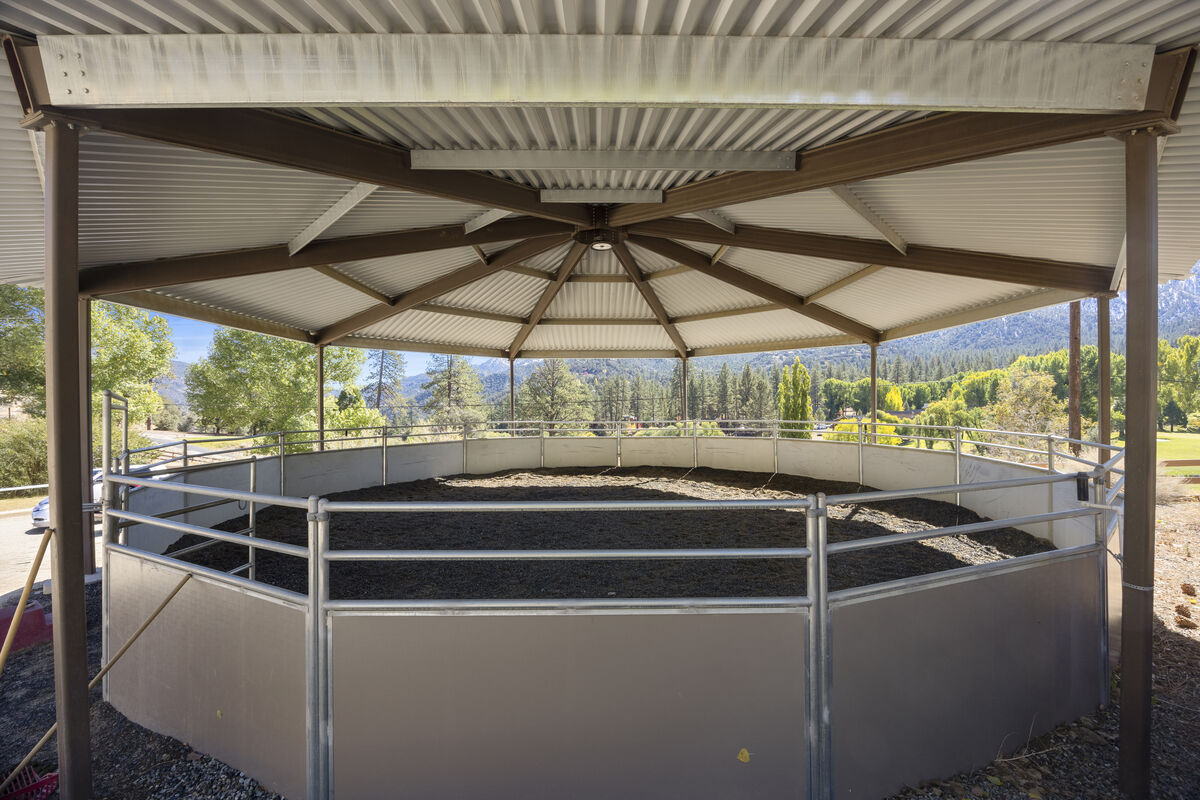 Covered round pen arena at PMC Equestrian Center with mountain views
