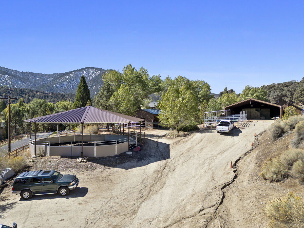 Round pen and barn with mountain backdrop at PMC Equestrian Center