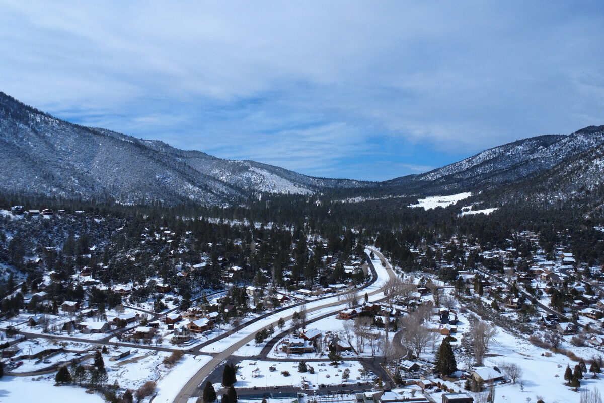 Pine Mountain Club community wide aerial view in winter snow