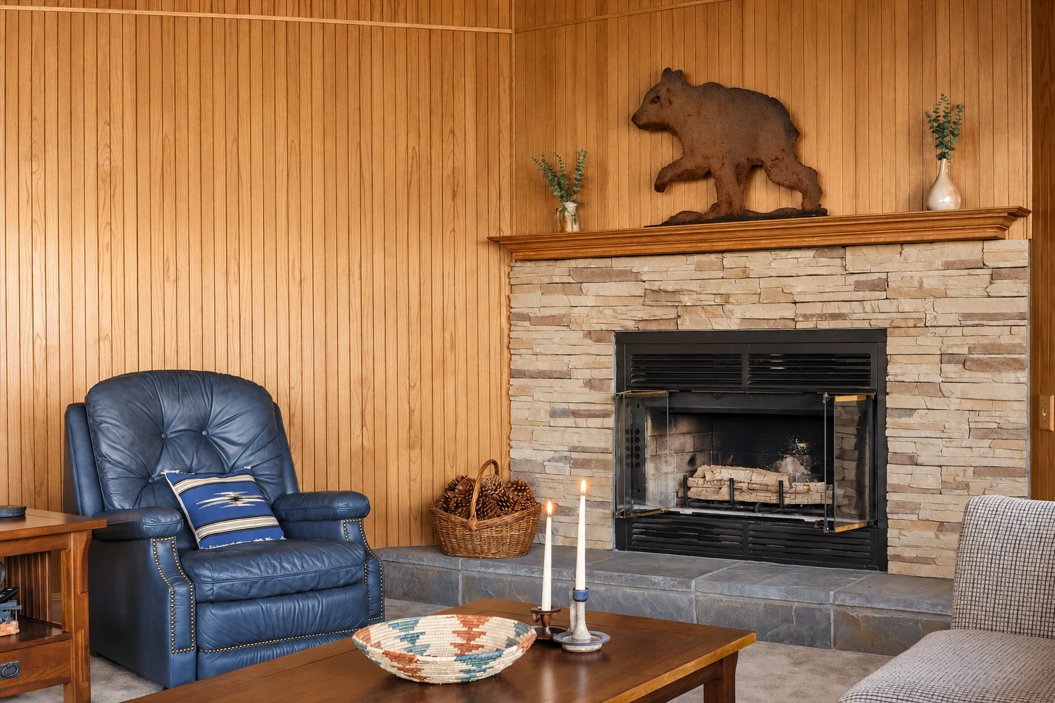 2104 Ironwood Drive — Stone fireplace surrounded by warm wood paneling