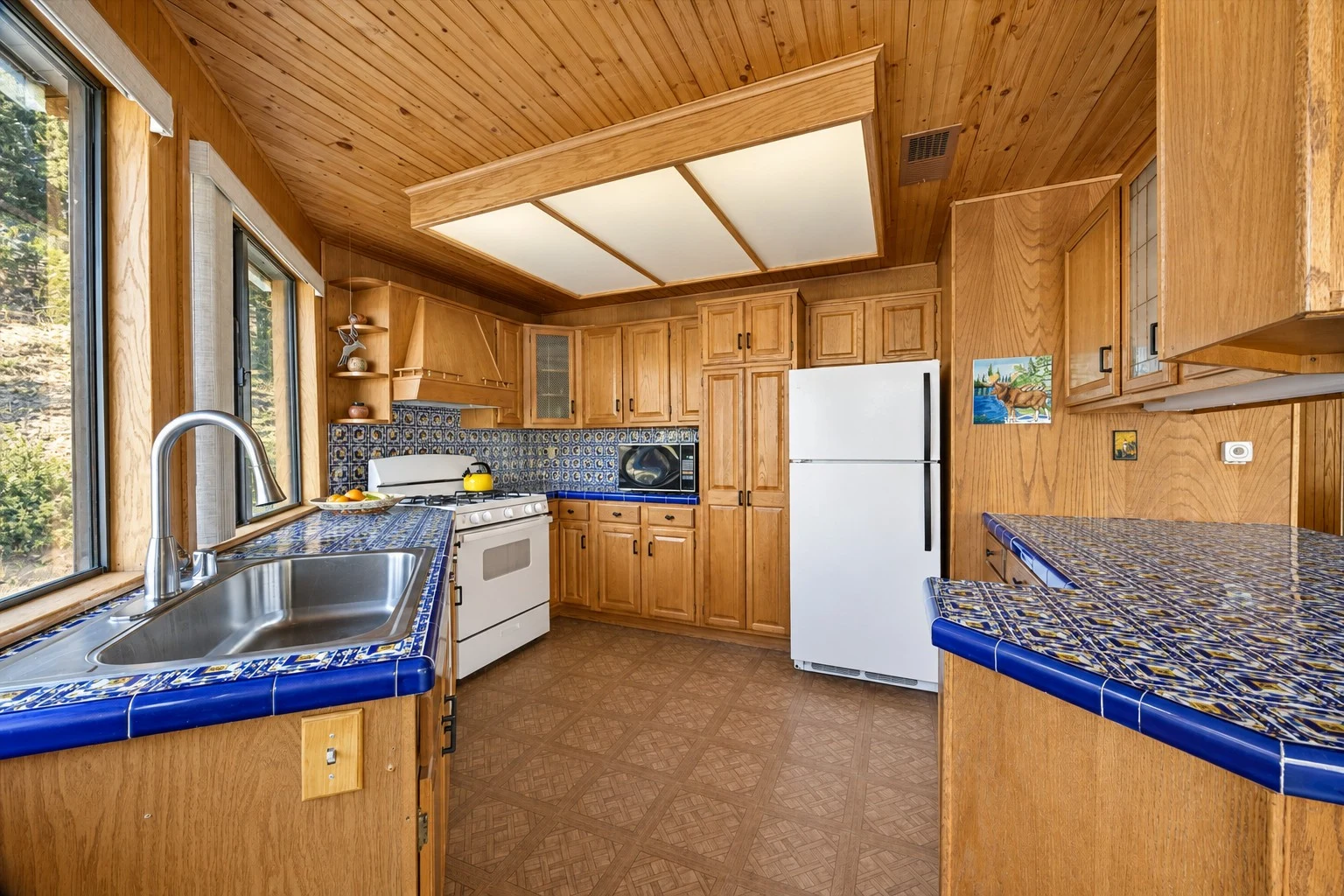 2104 Ironwood Drive — Kitchen with wood cabinets and blue tile counters