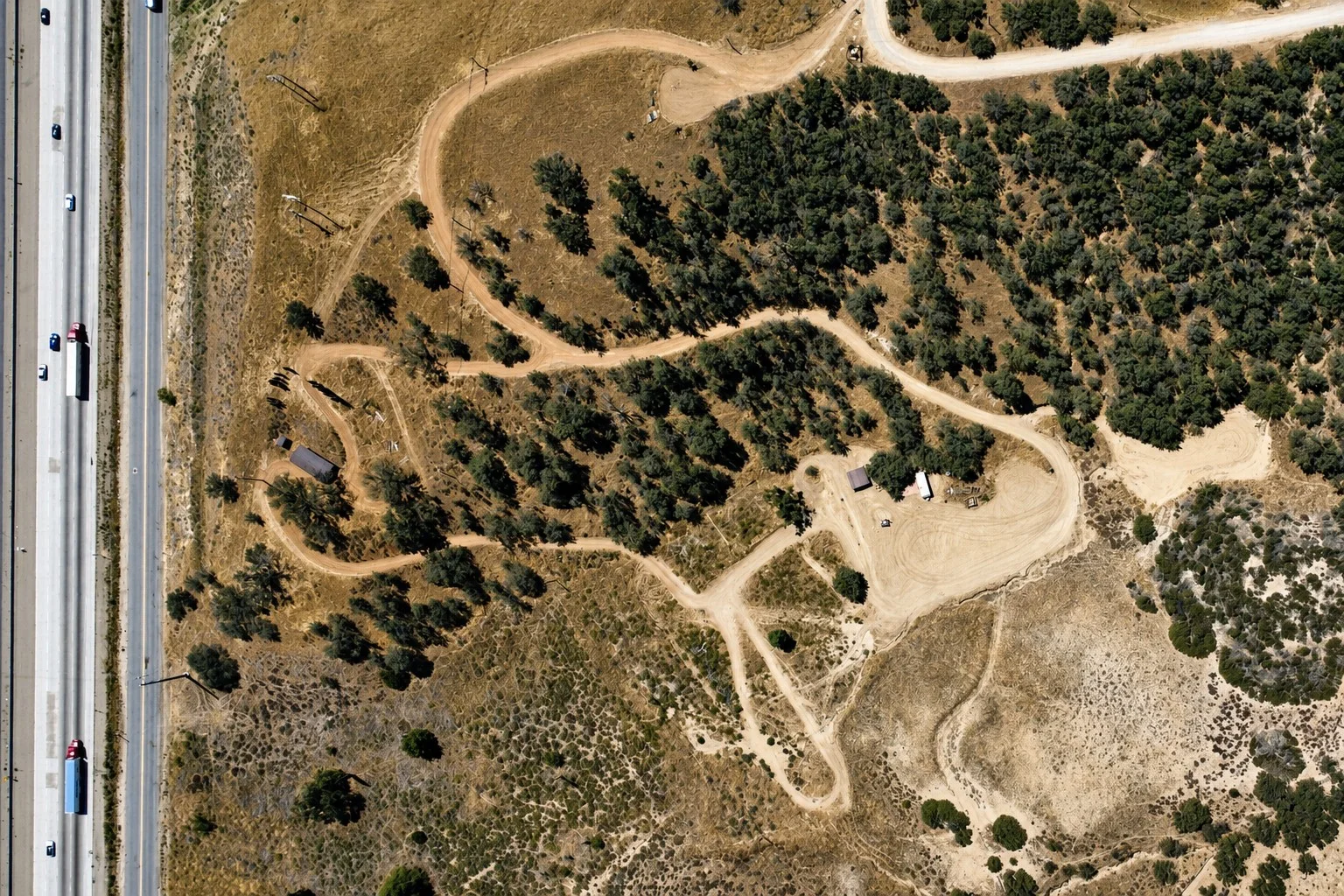 Overhead aerial showing the internal dirt-road network across the Ridge Route acreage