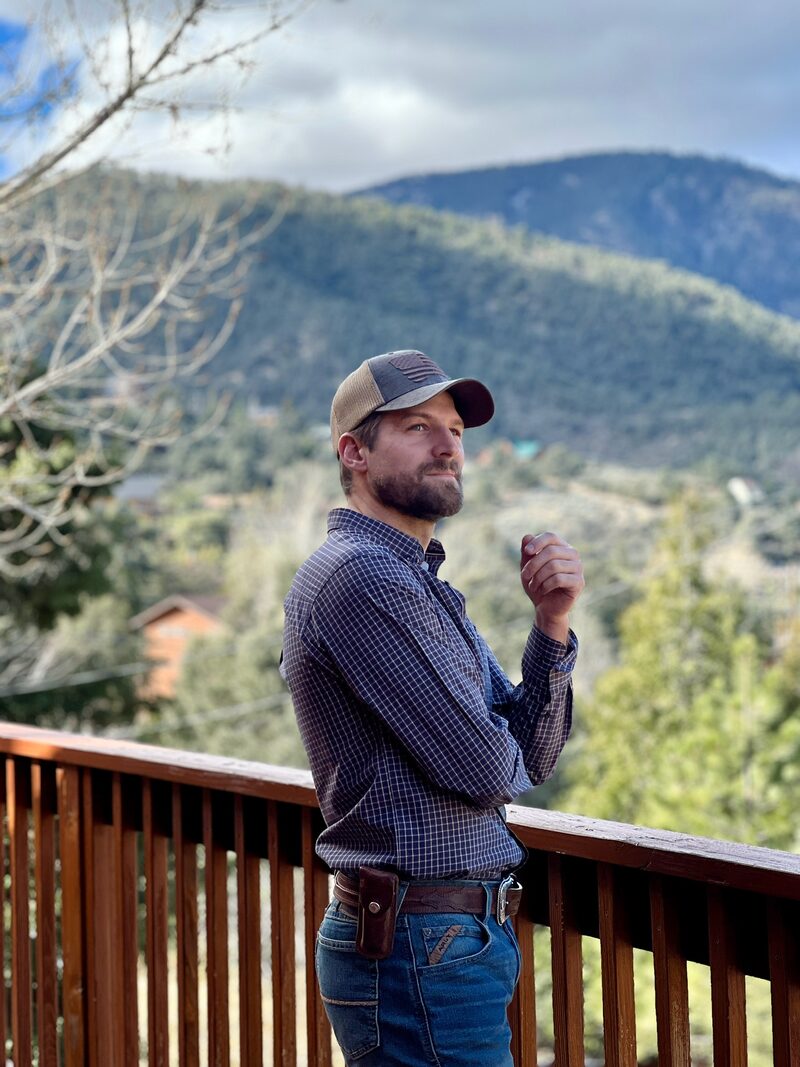 Tanner Brown overlooking the Frazier Mountain community from a deck