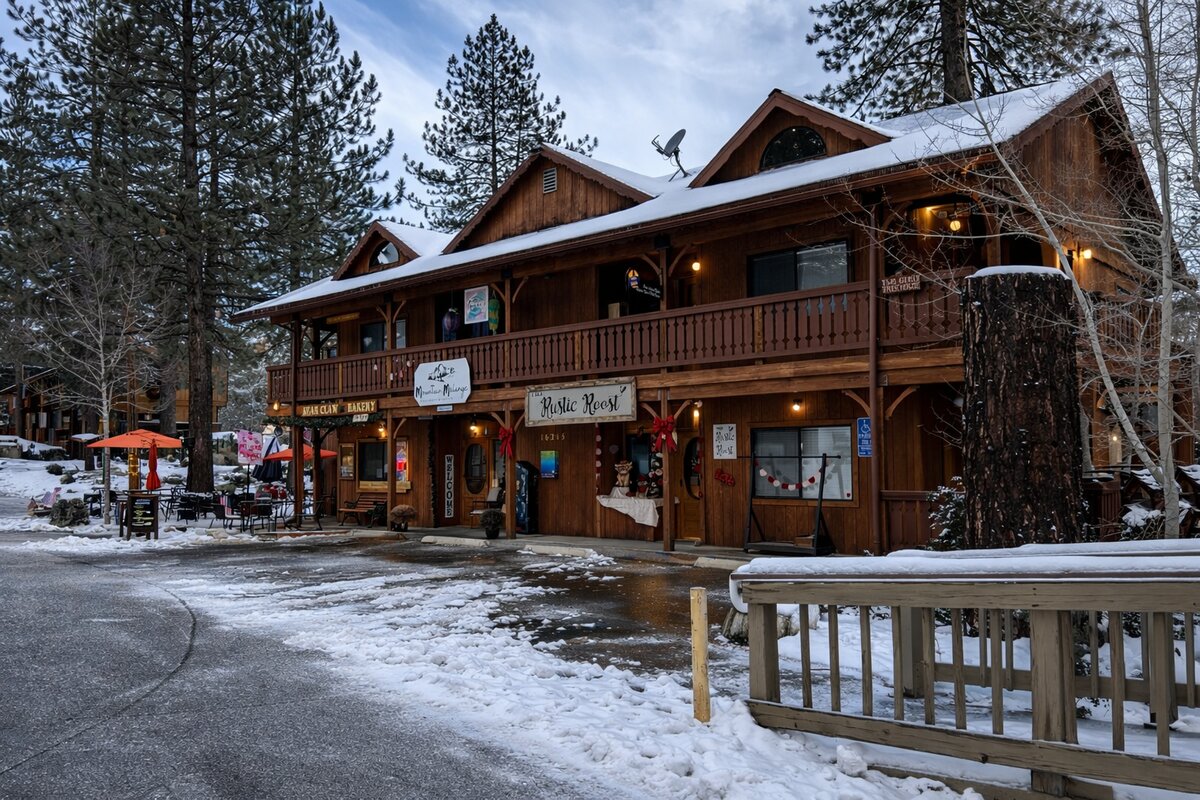 Bear Claw Bakery and Rustic Roost storefronts covered in winter snow in Pine Mountain Club Village