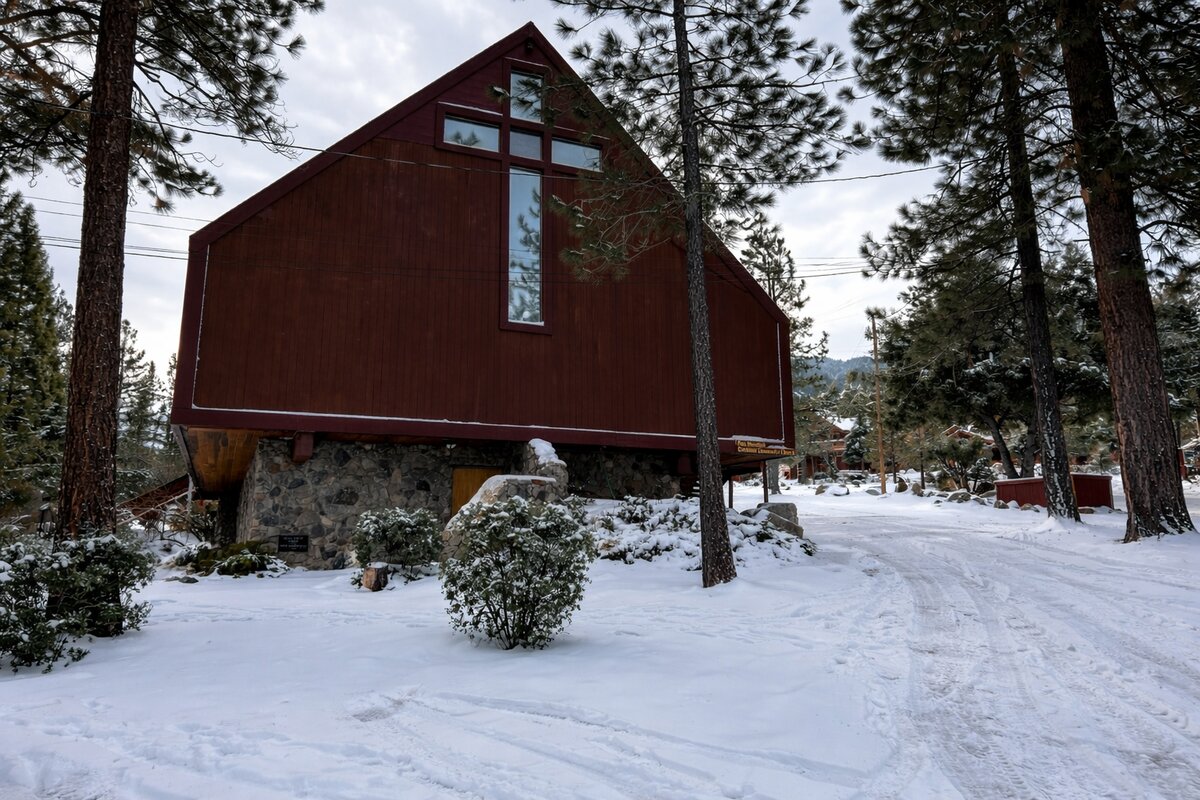 Pine Mountain Community Church A-frame building with snow and stone foundation