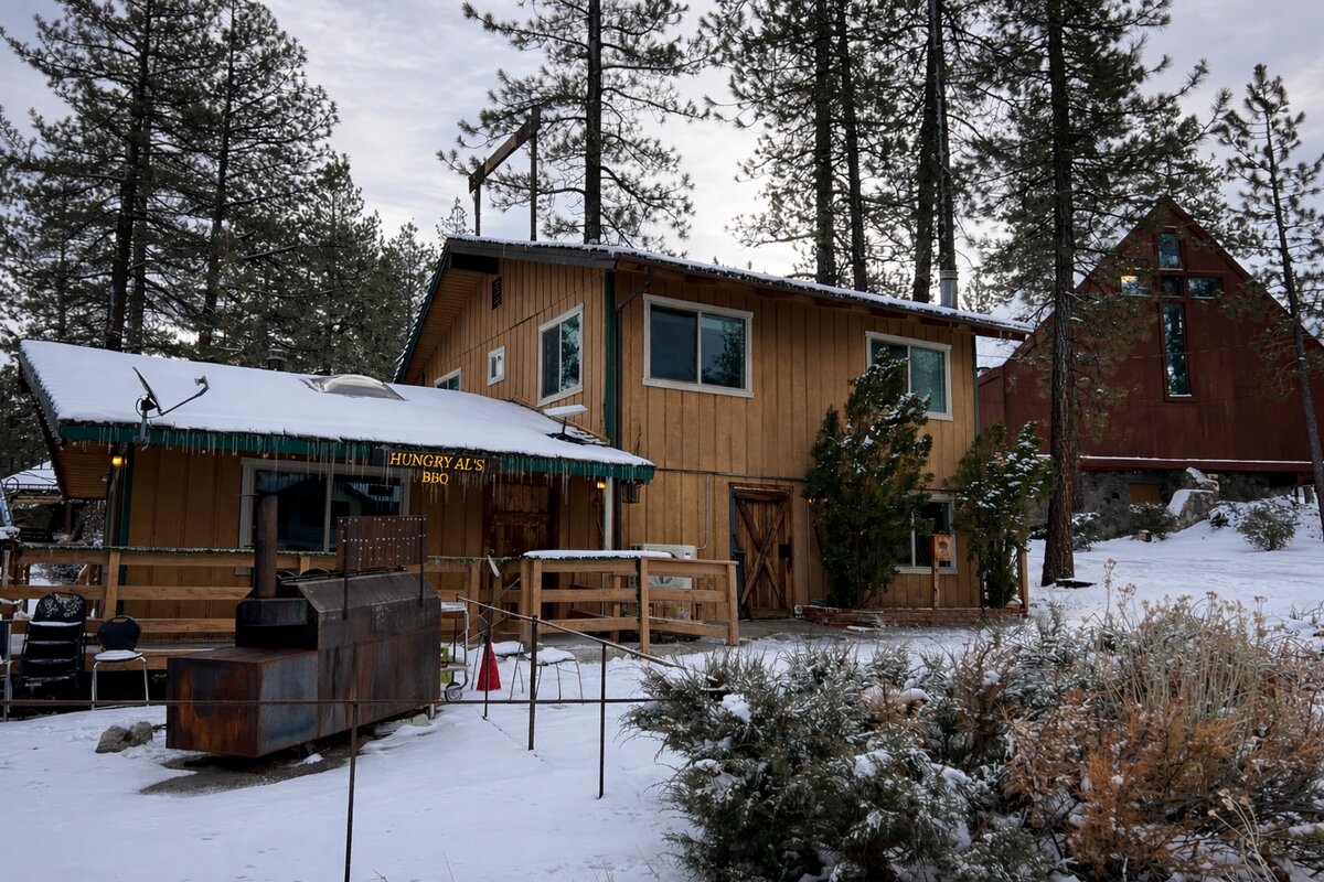 Hungry Al's BBQ restaurant with smoker and snow-covered grounds
