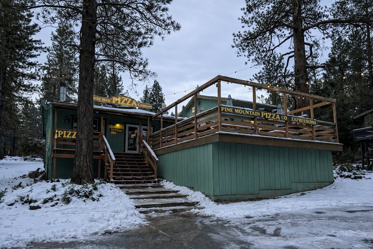 Pine Mountain Pizza Company restaurant with snow and string lights