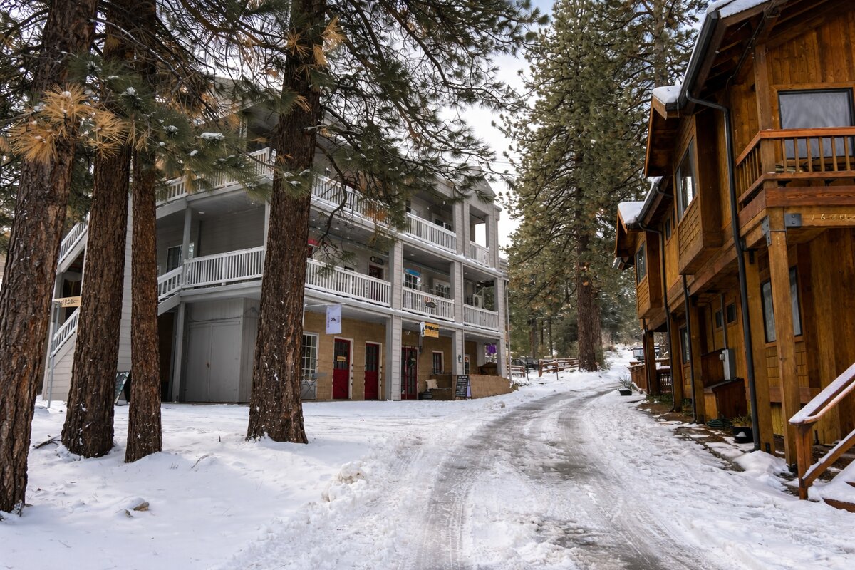 Pine Valley Lane buildings and walkways blanketed in snow in Pine Mountain Club